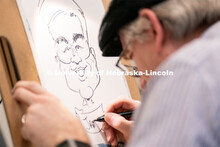 A caricature artist draws students during the End of Year Bash inside the East Campus Union on Satur