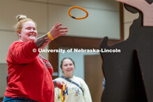 Students play carnival games during the End of Year Bash inside the East Campus Union on Saturday, A