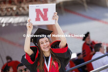 Skylar Hanson waves to her family as she returns to her seat with her diploma. UNL undergraduate com
