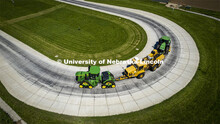High angle view of a tractor as it pulls the test car (yellow) and an additional tractor for weight 