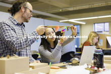 Lloyd “Bud” Shenefelt, Assistant Professor of Architecture, critiques a hanging design by first 