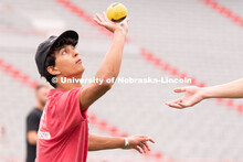 Husker fans play Spike Ball on the field at the Nebraska vs Northwestern football watch party in Mem