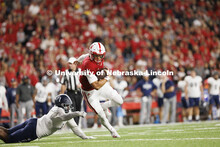 Nebraska football players work to defeat Georgia Southern. Nebraska vs. Georgia Southern football in