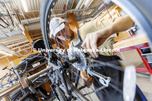 Drew Roper, a junior from Omaha, works as a bike mechanic in the shop. Outdoor Adventures Bike Shop 