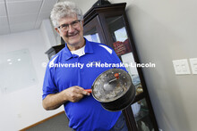 Norm Krug proudly shows his grandfather’s popcorn popper. The popper resides in a case in the comp