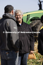 Sample in hand, Norm Krug talks with Andrew McHargue before taking the sample back to the office for
