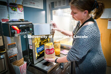Freshman Emma Georgia helps prepare popcorn for moviegoers at the Ross Theater November 9, 2022. 