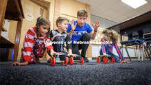 Spencer Knight gets three students and their rubber-band powered cars lined up for a race. Nebraska 