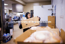 Bree Bell, a freshman from Omaha, sorts boxes of food at Matt Talbot Tuesday morning. Nebraska Unive