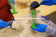 As part of MLK Week events, volunteers scoop oatmeal into bags as they assemble hunger kits. The goa