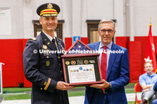 Chancellor Ronnie Green accepts a shadowbox from Lieutenant Colonel Mark Peer. ROTC Joint Service Ch