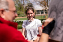 Junior Human Development and Family Sciences major Molly Storm laughs as a caricature of her is draw