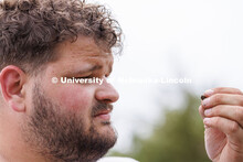 Dalton Carder, a senior in anthropology, looks at a piece sifted from his dig area. LuAnn Wandsnider