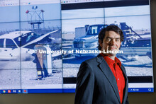 Cody Stolle, Research Assistant Professor, Midwest Roadside Safety Facility, stands in front of a cr