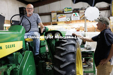 Richard Endacott gestures to producer Jamie Vesay as they discuss whether a restored tractor should 