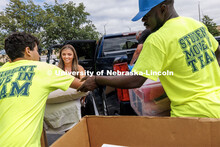 Carmela VanZyl hands over pillows to the move-in team as she moves into her Smith Residence Hall roo