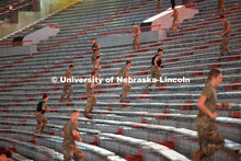 Army ROTC cadets spring up the steps in Memorial Stadium. ROTC cadets and midshipmen run 110 flights