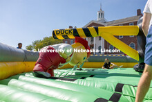 Lil Red' ducks under spinning inflatable at Hanging with the Huskers event. September 29, 2023. 