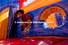 Savan Patel jumps through an inflatable obstacle course at Hanging with the Huskers event September 