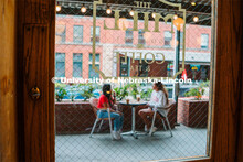 Grace Patel (right) and Isela Tercero on the patio of The Mill in the Haymarket. About Lincoln at Co