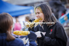 Lani Bohmont digs into an ear of roasted corn at Cornstock. Homecoming parade and Cornstock. October