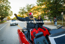 Chancellor Rodney Bennett and his wife, Temple, wave to the crowd as they roll down R Street. Homeco