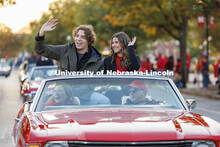 Homecoming royalty candidates Cordell Vrbka and Rachel Morros wave to the crowd along the parade rou