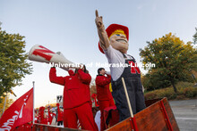 Herbie Husker and Amani Mfinanga cheer from a tractor-pulled wagon in the Homecoming parade. October