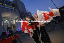 Cornhusker Marching Band color guard members Alyssa Johnson and Cheyanne Pace cheer as they pose in 