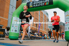 Runners cross the finish line. The Good Life Halfsy half marathon runs through the streets of Lincol