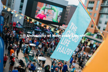 People watch the runners cross the finish line on the big screen t.v. in the Haymarket. The Good Lif