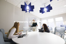 Madalyn Schoneman, works on a white board with Alexis Tenorio, left, and Sarah Danahy in the Knoll R