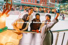 Students stop for a selfie at the Railyard Rink. Ice skating in the Haymarket. Photos for About Linc