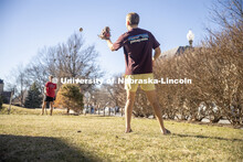 Beta Theta Pi Fraternity brothers play catch in front yard of their Fraternity house. February 20, 2