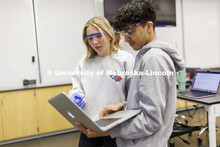 Biology students read their experiment notes on a laptop. LIFE 120L - Fundamentals of Biology lab in