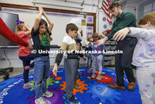 While students close their eyes and pretend they are trees, Jack Hilgert, drops red, yellow and blue