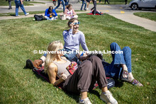 A group of friends hang out while waiting for the eclipse to start at the East Campus Loop. April 8,
