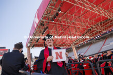 A grad smiles after receiving his diploma. Undergraduate Commencement in Memorial Stadium. May 18, 2