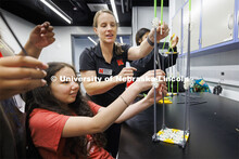 Christine Wittich, Assistant Professor in Civil and Environmental Engineering, helps Eve Chavez buil