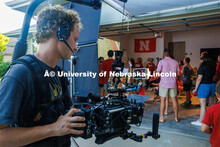 A film crew records a garage husker watch party in Omaha. Behind the scenes photo for the university