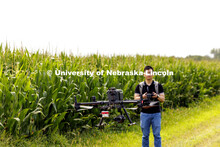 Biquan Zhao, Post-Doc Research Associate in Animal Science, flies a drone over the corn fields north