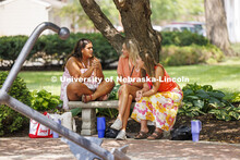 Recruits and Rho Gammas keep cool in the shade of Delta Gamma sorority while they await the next rou