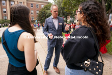 Dean of the College of Arts and Sciences Mark E. Button (center) speaks to incoming freshmen student