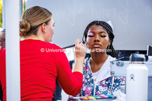 A student has a design painted on her face at the Cornchella festival. 2024 Homecoming celebration. 