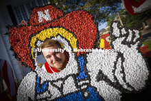 Husker cheer squad member Newt Johnson tries out the Herbie lawn decoration in front of the Phi Kapp