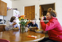 Breanna Gilmore, Sarah Dilley and McKenna Carr eat lunch together in their apartment that is part of