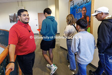 NSE student ambassador Jhovany Millan (left) welcomes families during Spanish Visit Day. October 26,