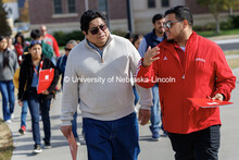 NSE student ambassador Jhovany Millan (right) speaks with families as they take a campus tour during