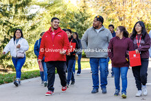 NSE student ambassador Jhovany Millan, center-left, speaks with families as they take a campus tour 