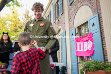 A fraternity member dressed as Maverick from Top Gun passes out candy in front of the Pi Beta Phi So